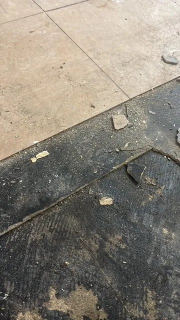 Black bitumen mastic floor removal in a SW18 flat